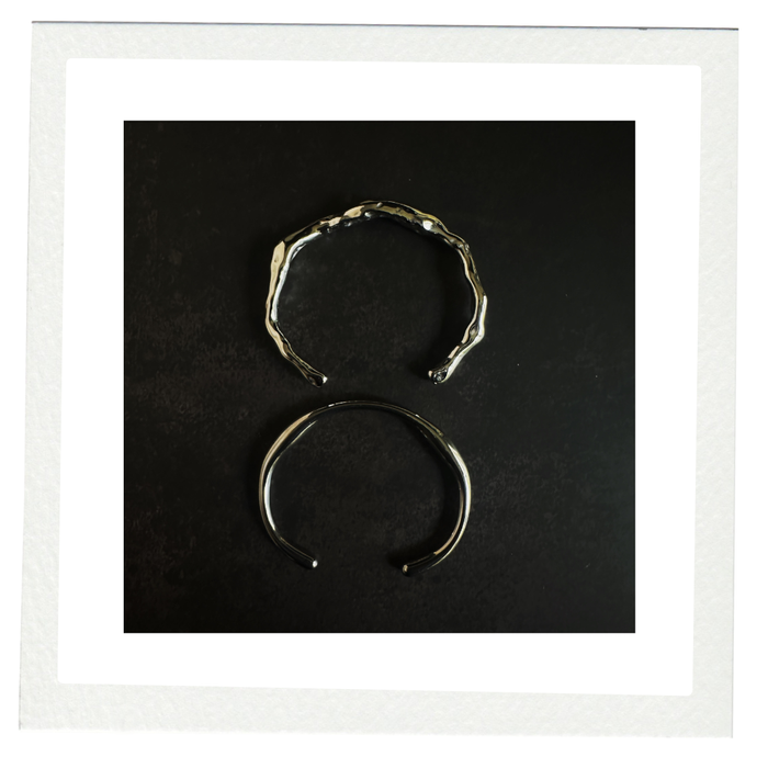 Two silver demi-fine bracelets on a black background, Cocoa Ari heritage jewelry NYC