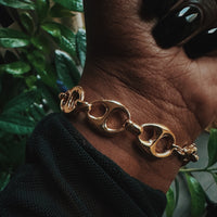 Gold mariner chain bracelet on wrist, demi-fine jewelry by COCOA ARI, modern design