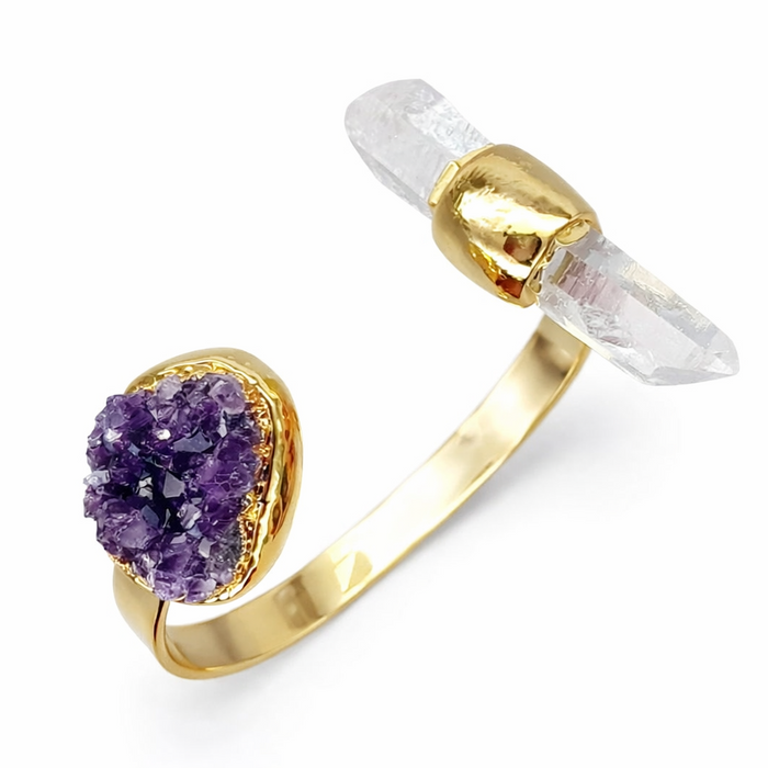 Gold ring with clear crystal and purple amethyst on a white background