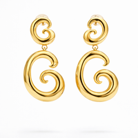 Gold swirl drop earrings by COCOA ARI, modern small-batch demi-fine jewelry on white background