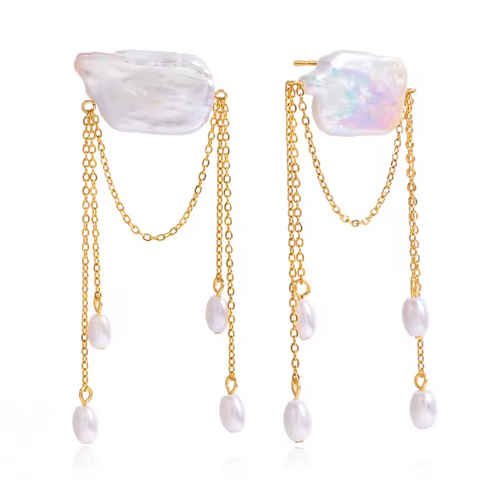 Pair of earrings with gold chains and gemstones on a white background