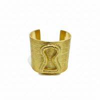 Gold bracelet on a magazine with 'Add to cart' and 'Buy now' buttons.