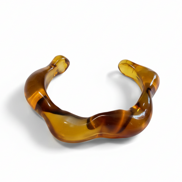 Cocoa Ari wavy amber resin cuff bracelet, modern demi-fine jewelry on white background