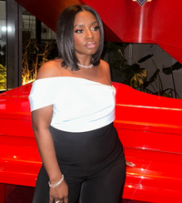 WOMAN WEARING DIAMOND AURORA NECKLACE IN FRONT OF RED PIANO 