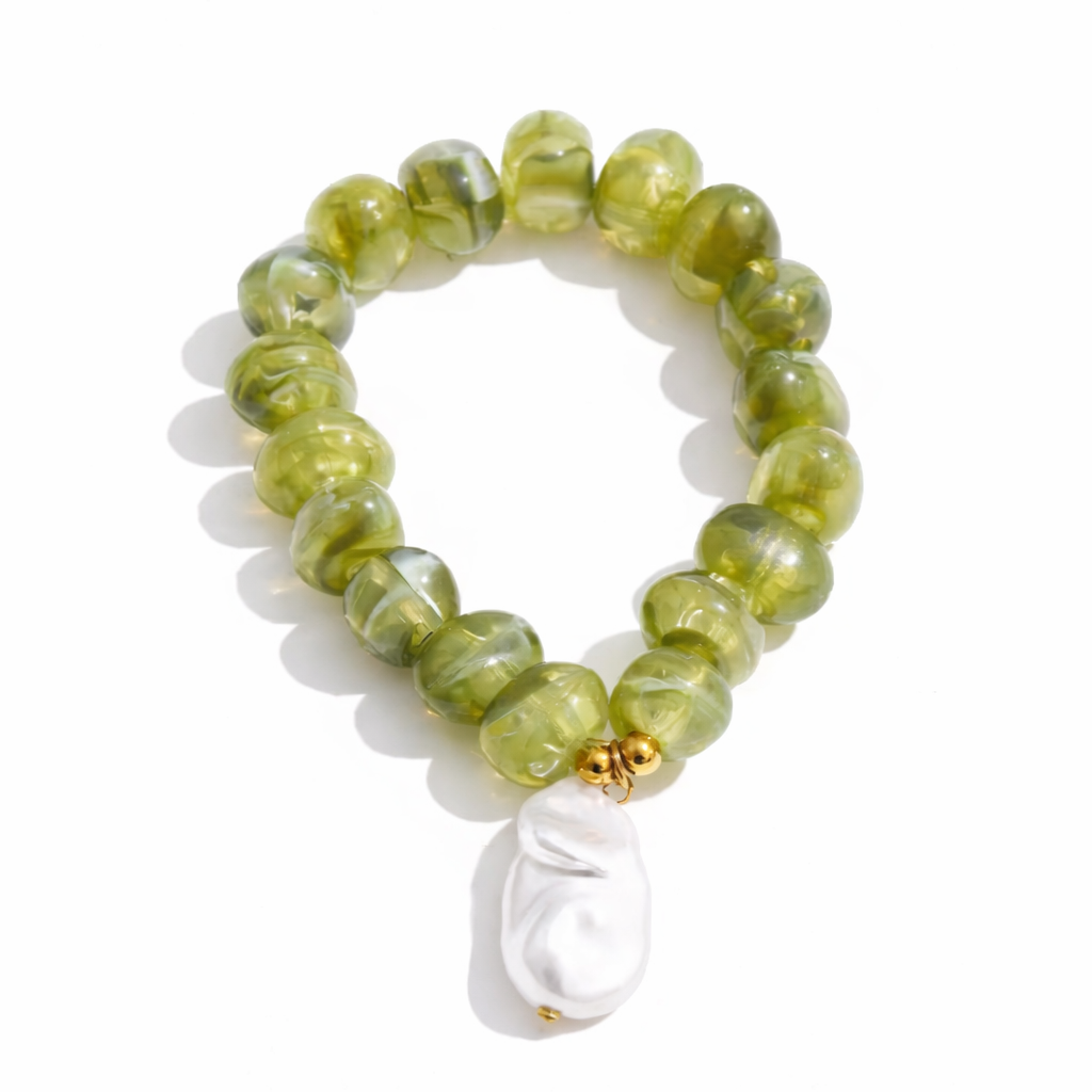 Green beaded bracelet with a white pearl charm