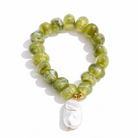 Green beaded bracelet with a white pearl charm