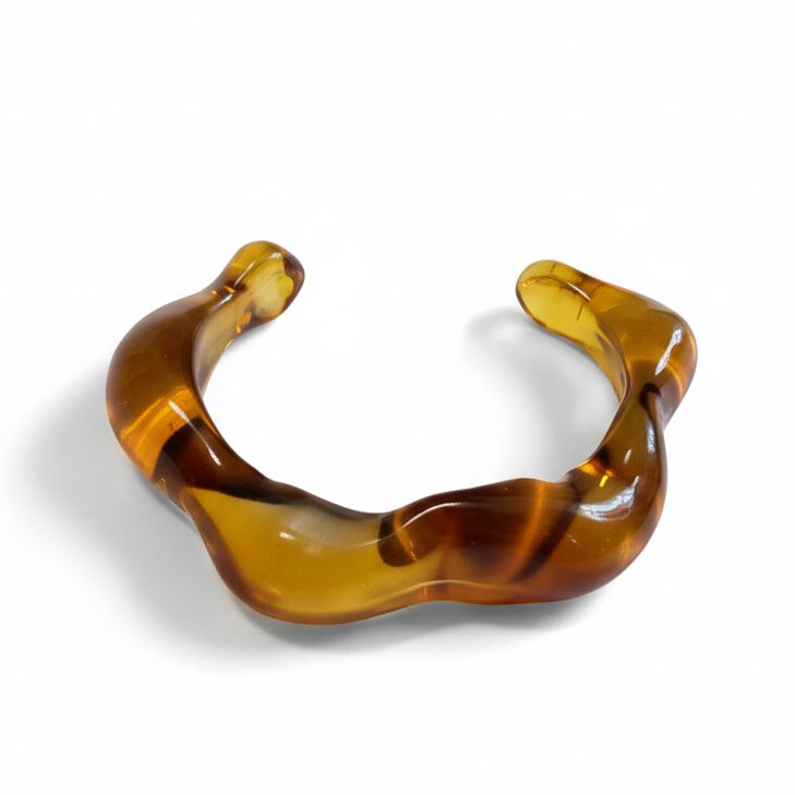 Cocoa Ari wavy amber resin cuff bracelet, modern demi-fine jewelry on white background
