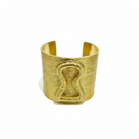 Gold bracelet on a magazine with 'Add to cart' and 'Buy now' buttons.