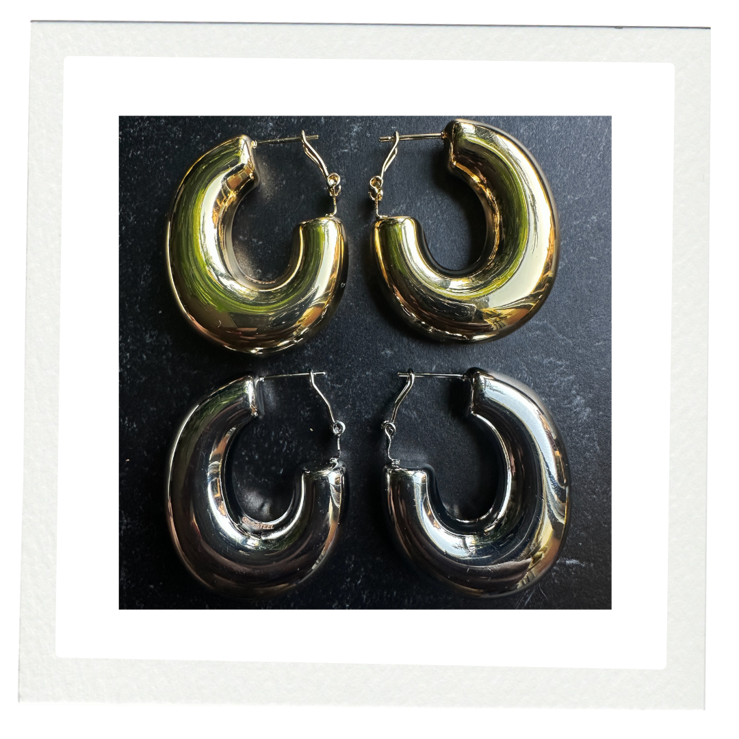 COCOA ARI Avenue Duo gold and silver chunky hoop earrings on black background