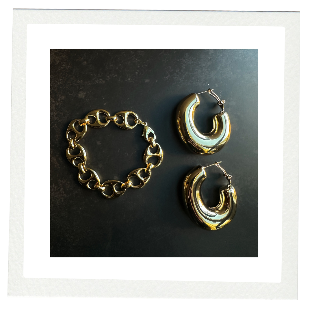 COCOA ARI gold hoop earrings and chunky chain bracelet on black background