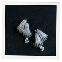 Pair of silver claw tassel earrings with clear stones