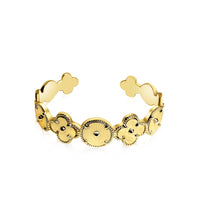 Gold bracelet with teddy bear charms on a white background