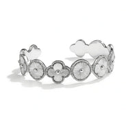Silver bracelet with floral and heart designs on a white background