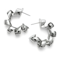 Silver telephone cord hoop earrings on a white background