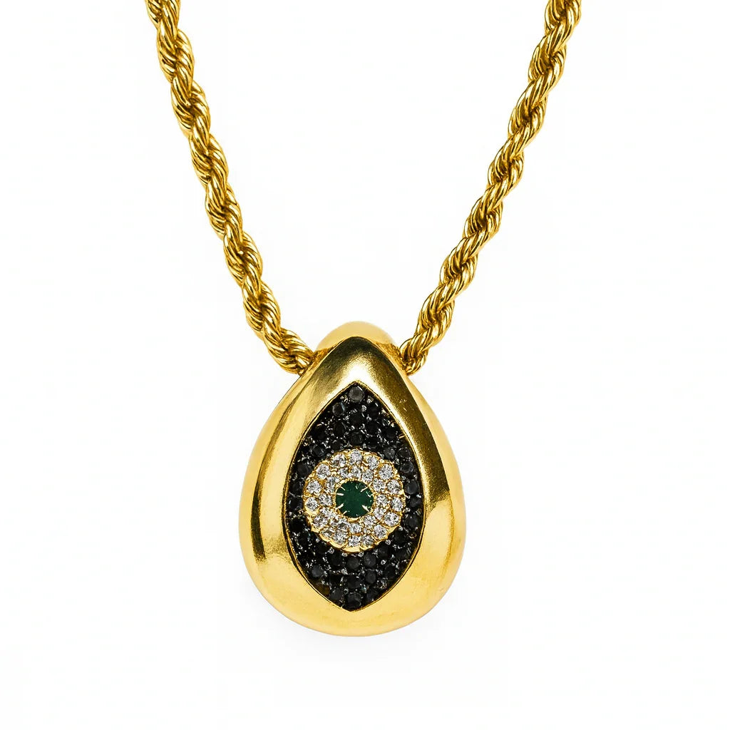 Gold necklace with a teardrop-shaped pendant featuring black and green gemstones on a white background