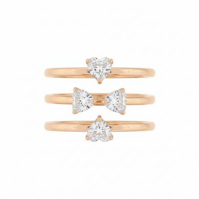 Gold rings with heart-shaped gemstones on a product page.