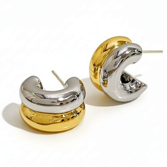 Pair of gold and silver hoop earrings on a white background