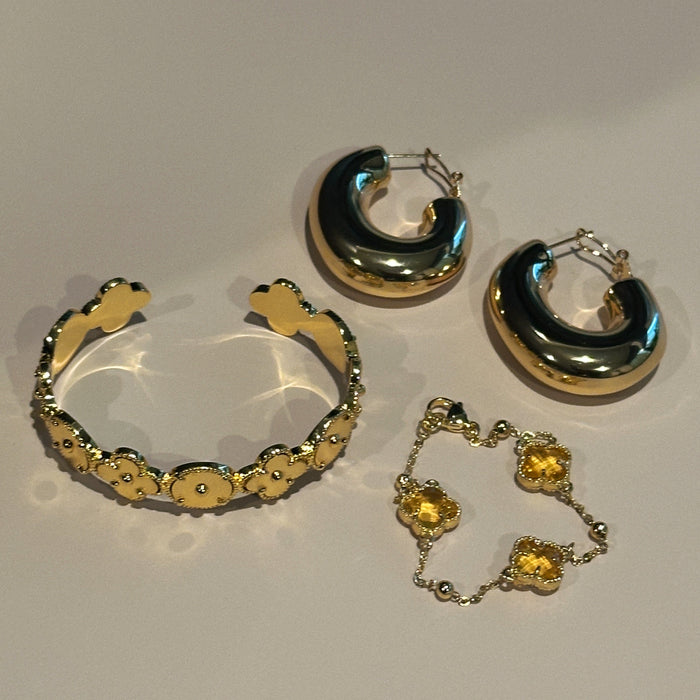 gold bracelets and hoop earrings