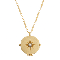 Gold necklace with a star-shaped pendant on a white background
