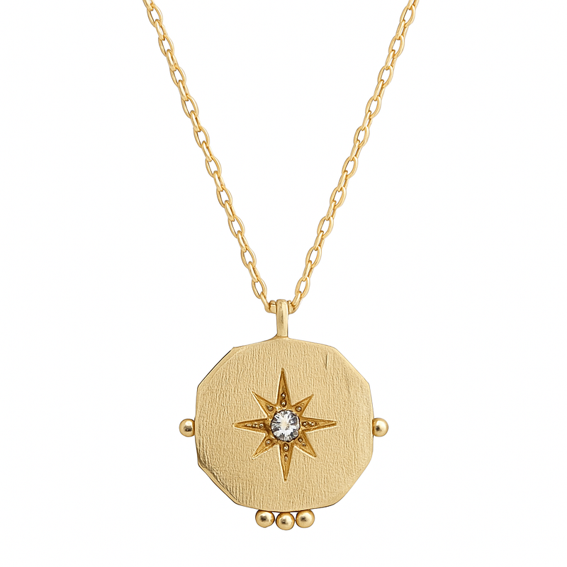 Gold necklace with a star-shaped pendant on a white background