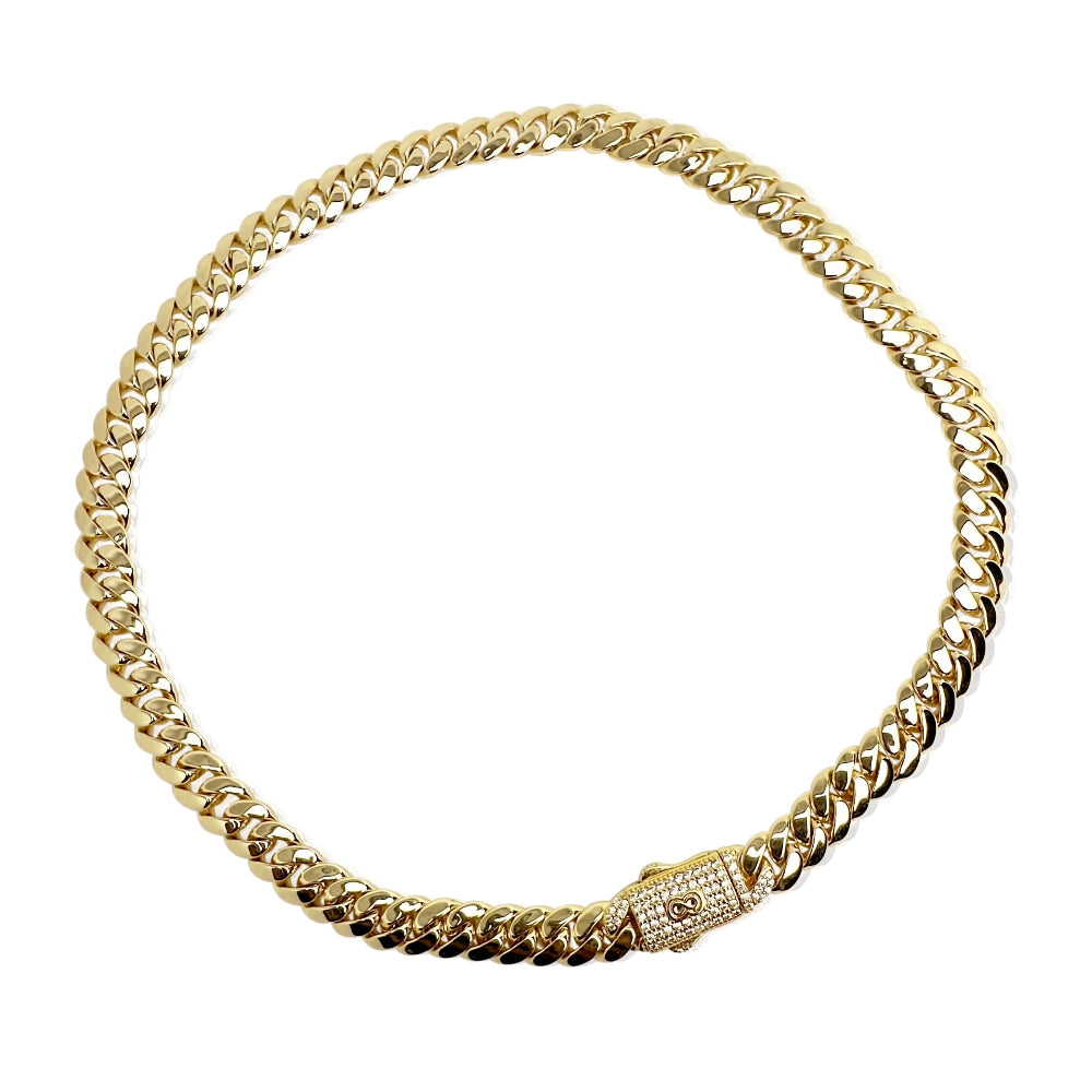 Gold chain necklace with a clasp on a white background