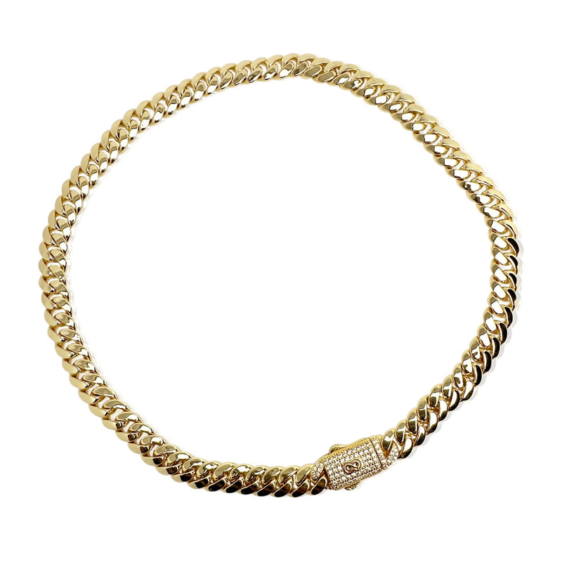 Gold chain necklace with a clasp on a white background