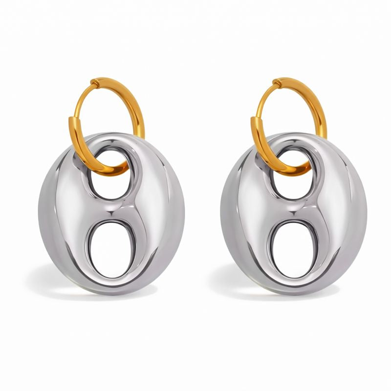 Pair of earrings with gold and silver circular design on a white background