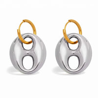 Pair of earrings with gold and silver circular design on a white background
