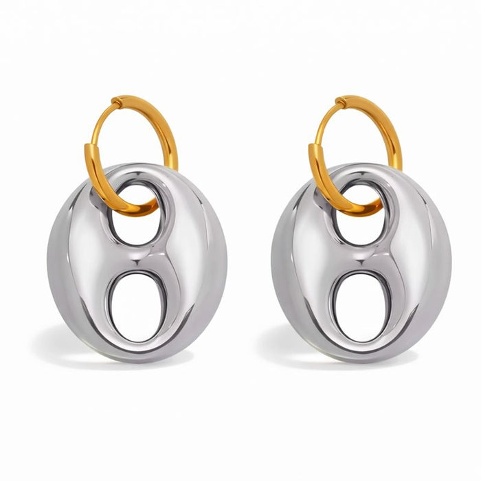 Pair of earrings with gold and silver circular design on a white background