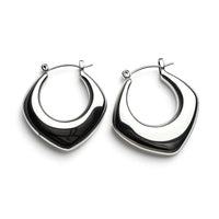 COCOA ARI silver lunar curve hoop earrings, modern geometric demi-fine jewelry on white background
