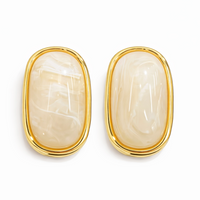 Pair of gold earrings with beige stones