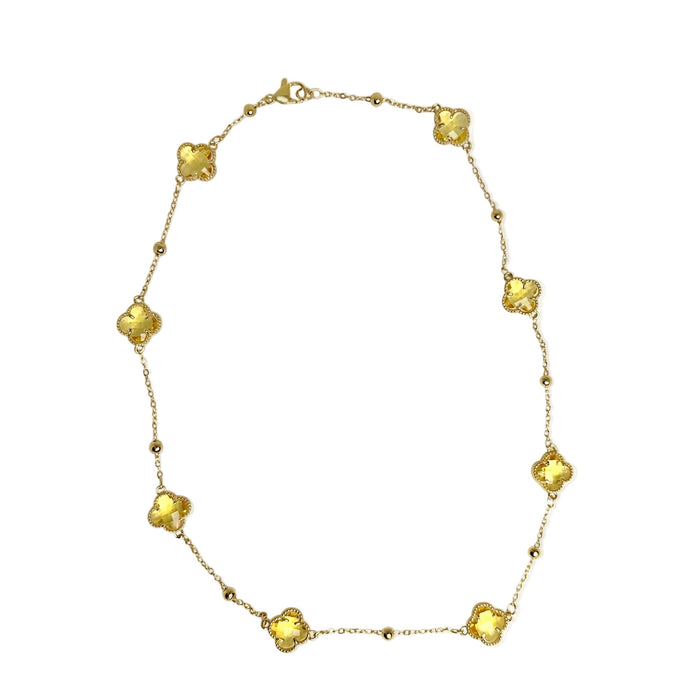 Gold station necklace with yellow crystal clover motif stones white background