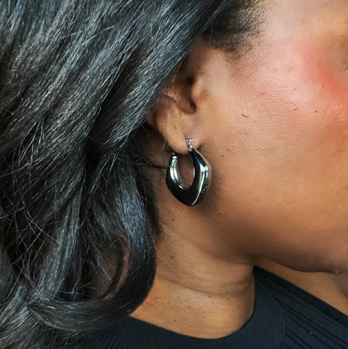 Cocoa Ari modern black hoop earring on ear, demi-fine jewelry designed in NYC